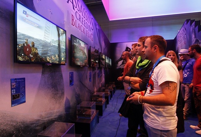 Visitors play Assassins Creed IV Black Flag with Playstation 4 during the Gamescom 2013