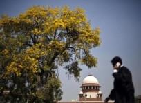 a-lawyer-walks-past-outside-indian-supreme-court