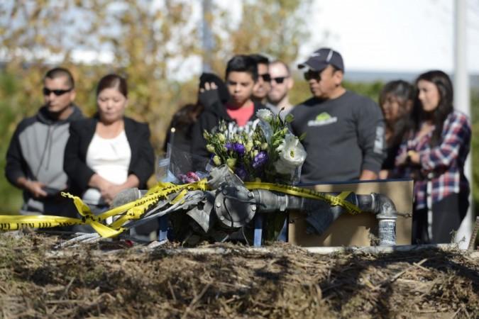 Fans place flowers at the scene of a fiery crash that killed Paul Walker