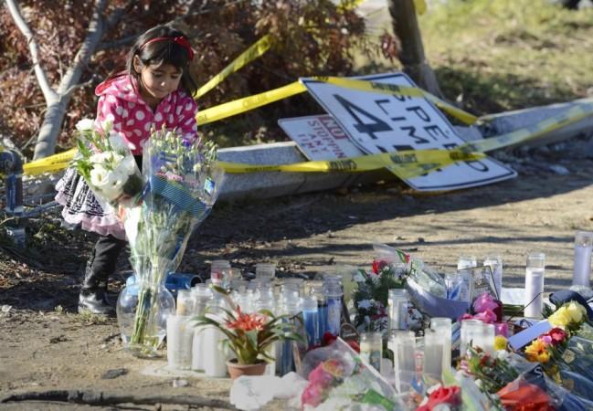 A girl places flowers at the scene of the car crash where actor Paul Walker was killed in the Santa Clarita area of Los Angeles Paul Walker