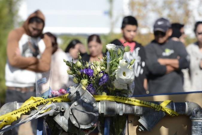 Fans place flowers at the scene of a fiery crash that killed Paul Walker
