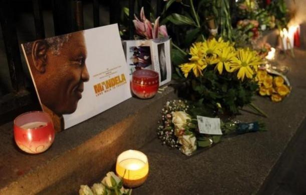 Flowers, candles and tributes are left in memory of Nelson Mandela outside the South African High Commission across from Trafalgar Square in London Flowers, candles and tributes are left in memory of Nelson Mandela outside the South African High Commission across from Trafalgar Square in London