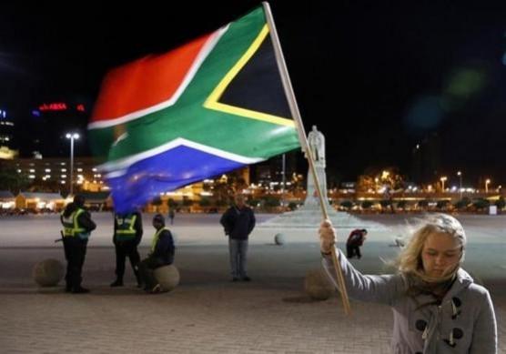 girl holds a South African national flag outside Cape Town City Hall, where Mandela made his first speech after his release from his 27year incarceration, December 6. girl holds a South African national flag outside Cape Town City Hall, where Mandela made his first speech after his release from his 27year incarceration, December 6.