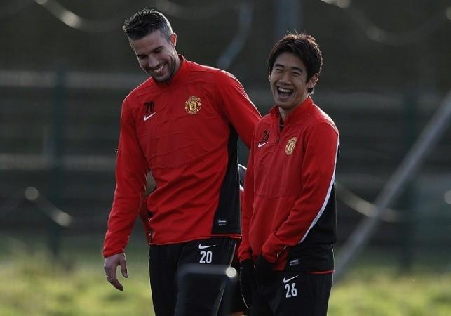 Manchester United's Robin Van Persie and Shinji Kagawa share a light moment during a training session, December 9. Reuters Manchester United Van Persie Kagawa