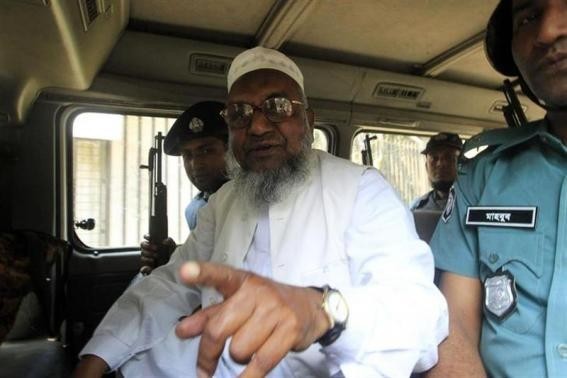 Bangladesh's Jamaat-e-Islami leader Abdul Quader Mullah gestures as he talks from a police van after a war crimes tribunal sentenced him to life imprisonment in Dhaka in this file photo. (Reuters)