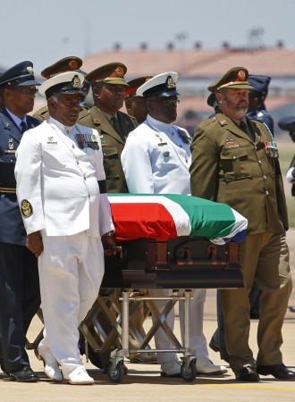 The coffin of Mandela is escorted aboard a military cargo plane after a send-off ceremony in Pretoria Nelson Mandela