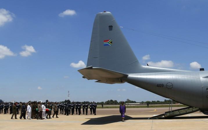 The coffin of Mandela is escorted aboard a military cargo plane after a send-off ceremony in Pretoria Nelson Mandela