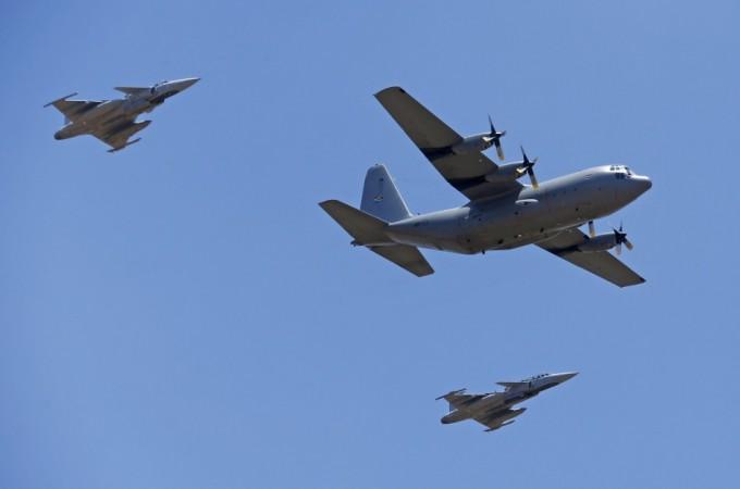 An C-130 transporting the coffin of Mandela is escorted by Jas Gripen fighter jets while taking off after a send-off ceremony in Pretoria Nelson Mandela