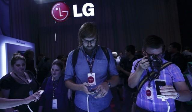 Journalists look at the new LG G2 smart phone following its debut at a news conference in New York. LG G3 Roundup: Expected Specifications, Release Date Details