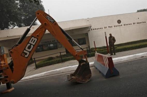 A policeman stands next to a bulldozer removing the security barriers in front of the US embassy in New Delhi December 17 policeman stands next to a bulldozer removing the security barriers in front of the U.S. embassy in New Delhi December 17, 2013