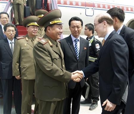 Choe Ryong-hae (L), director of the General Political Bureau of the Korean People's Army (KPA) of North Korea, shakes hands with a Chinese official upon arrival at the airport in Beijing, in this May 22, 2013 picture released by the North Korea'
