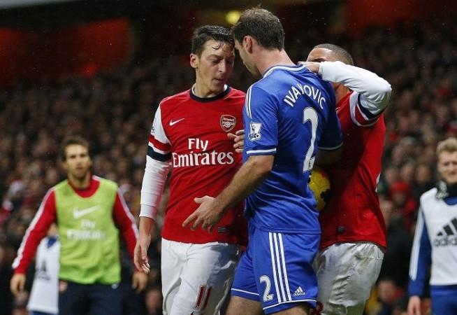 Arsenal midfielder Mesut Ozil and Chelsea defender Branislav Ivanovic have a go at each other during their English Premier League game, December 23. Reuters Arsenal Ozil Chelsea Ivanovic