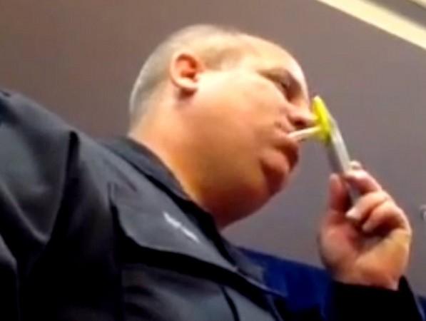LAPD officer demonstrating the oral swab tool