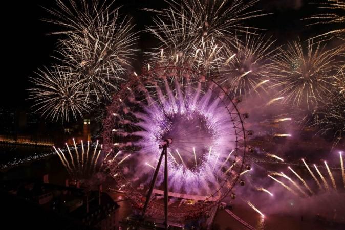 Fireworks explode across a London skyline near the London Eye during New Year celebrations in London New Year 2014