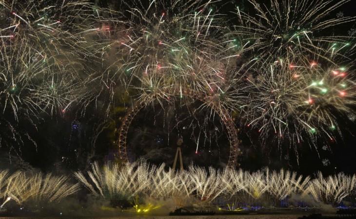 Fireworks explode around the London Eye wheel during New Year celebrations in central London New Year 2014
