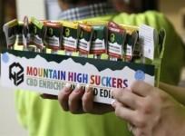n-employee-brings-out-a-display-of-drug-infused-candies-at-the-botana-care-marijuana-store-just-before-opening-the-doors-to-customers-for-the-first-time-in-northglenn-colorado-january-1-2014
