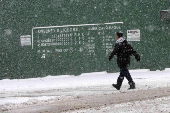 A pedestrian walks past a replica of the Fenway Park scoreboard during a winter nor'easter snow storm in Lawrence, Massachusetts January 2, 2014. A pedestrian walks past a replica of the Fenway Park scoreboard during a winter nor'easter snow storm in Lawrence, Massachusetts January 2, 2014.