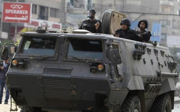 Riot police look from their armoured personnel vehicle during clashes with supporters of Muslim Brotherhood and ousted Egyptian President Mohamed Mursi at Nasr City district in Cairo. Riot police look from their armoured personnel vehicle during clashes with supporters of Muslim Brotherhood and ousted Egyptian President Mohamed Mursi at Nasr City district in Cairo, January 3, 2014.