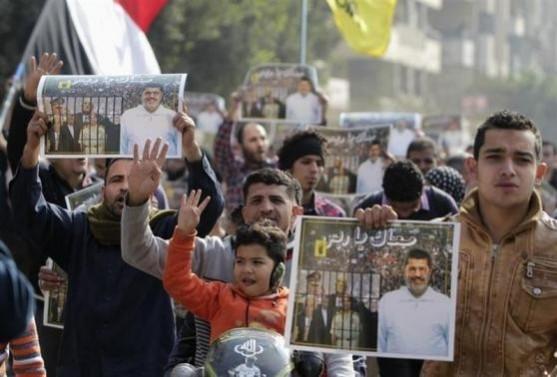 Supporters of the Muslim Brotherhood and ousted Egyptian President Mohamed Mursi protest against the military and interior ministry, while making the four-finger Rabaa gesture, at Nasr City district Supporters of the Muslim Brotherhood and ousted Egyptian President Mohamed Mursi protest against the military and interior ministry, while making the four-finger Rabaa gesture, at Nasr City district