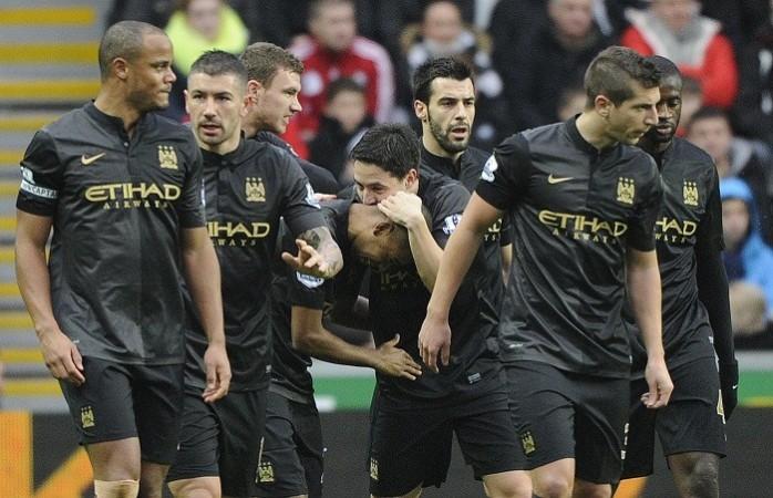 Manchester City players celebrate Fernandinho's goal against Swansea City in the English Premier League, January 1. Reuters Manchester City Kompany Kolarov Negredo Nastasic