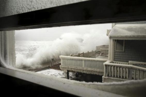 Waves crash into houses on Lighthouse Road during a winter nor'easter snow storm in Scituate, Massachusetts January 3, 2014. Waves crash into houses on Lighthouse Road during a winter nor'easter snow storm in Scituate, Massachusetts January 3, 2014.