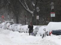 a-driver-works-to-dig-a-car-out-of-the-snow-during-a-winter-noreaster-snow-storm-in-boston-massachusetts-january-3-2014