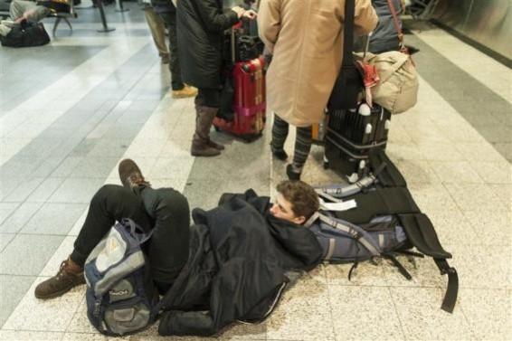 People wait for their delayed flights at LaGuardia Airport in New York People wait for their delayed flights at LaGuardia Airport in New York