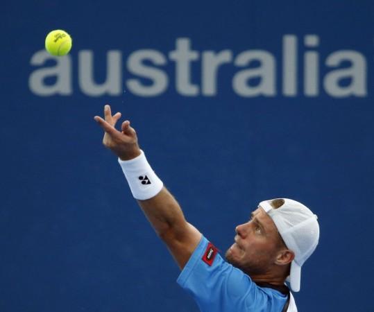 Lleyton Hewitt of Australia serves to Marius Copil of Romania during their men's singles match at the Brisbane International tennis tournament in Brisbane, January 3, 2014.