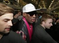 former-nba-basketball-player-dennis-rodman-c-is-protected-by-staff-members-as-he-arrives-at-the-beijing-capital-international-airport-to-leave-for-pyongyang-in-beijing-january-6-2014