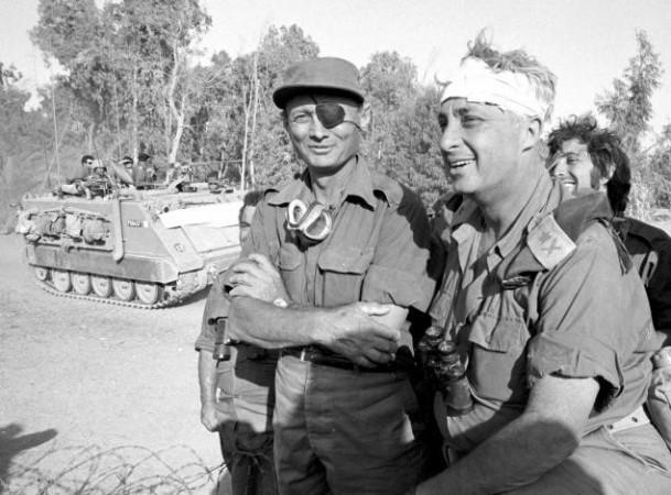 Moshe Dayan with an injured Sharon, then a major general in the reserves, on the western side of the Suez Canal in October 1973. The photo of the famed general with a bandaged head became an iconic image in his country./File Photo:Israel Defence Ministry/Reuters Moshe Dayan with an injured Sharon, then a major general in the reserves, on the western side of the Suez Canal in October 1973. The photo of the famed general with a bandaged head became an iconic image in his country./File Photo:Israel Defence Ministry/Reuters