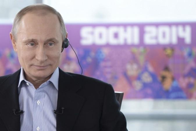 Russian President Vladimir Putin listens to a journalist's question during a televised news conference in Sochi January 19, 2014. REUTERS/Alexei Nikolsky/RIA Novosti/Kremlin