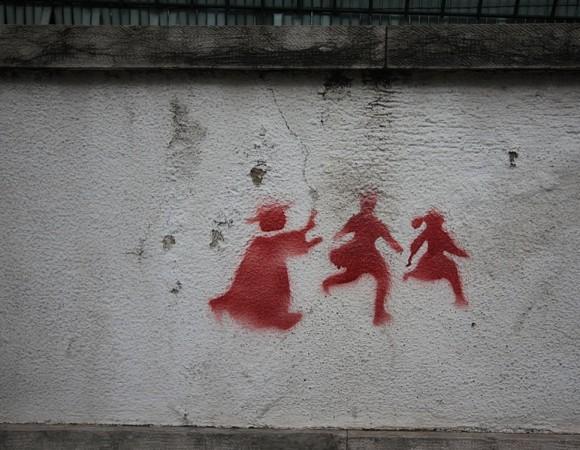 Graffiti on a wall in Lisbon depicting a priest chasing two children, denouncing the child abuse scandal that rocked the catholic church (which is still quite powerful in Portugal). Image taken 2 feb 2011/Creative Commons