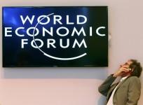 a-participant-speaks-on-his-mobile-phone-between-sessions-during-the-annual-meeting-of-the-world-economic-forum-wef-in-davos-january-22-2014-reuters-ruben-sprich