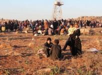 Syrian refugees, fleeing the violence, wait to enter Turkey on the Syrian-Turkish border in Shamm Alqrain village.