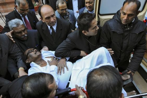 K Narayana Rao, an Indian parliamentarian, is rushed to a hospital after he collapsed inside the parliament in New Delhi February 13, 2014.
