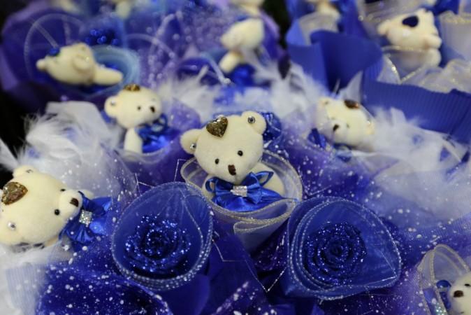Toy bears are used to decorate with blue roses as flowers products on sale for the upcoming Valentine's Day on Friday at a market, in Beijing, February 13, 2014. (Reuters) Valentine's Day