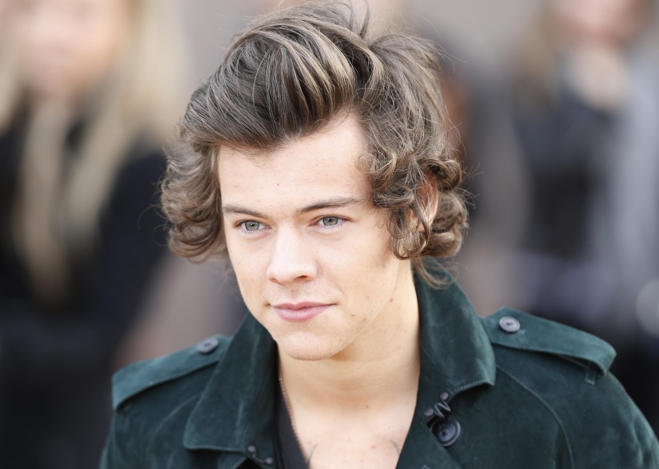 British singer Harry Styles from the band One Direction arrives to attend the presentation of the Burberry Autumn/Winter 2014 collection during London Fashion Week February 17, 2014. British singer Harry Styles from the band One Direction arrives to attend the presentation of the Burberry Autumn/Winter 2014 collection during London Fashion Week