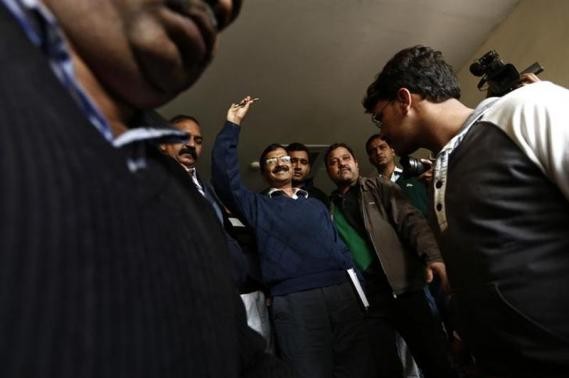 Arvind Kejriwal (C), chief of the Aam Aadmi (Common Man) Party (AAP), leaves after addressing the media during a news conference in New Delhi.