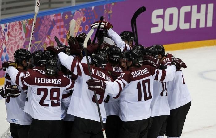 Team Latvia celebrate their victory over Switzerland on Wednesday. They face Canada in the quarterfinals of the Sochi Olympics. 18 February. Reuters. Team Latvia