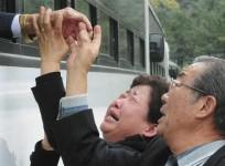 a-north-korean-man-l-waves-from-a-bus-as-his-south-korean-relatives-weep-after-a-luncheon-meeting-during-inter-korean-temporary-family-reunions-at-mount-kumgang-resort-october-31-2010