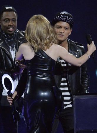 Singer Minogue congratulates Bruno Mars after he won the International Male Solo Artist award at the BRIT Awards, celebrating British pop music, at the O2 Arena in London Bruno Mars