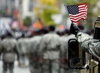a-u-s-armed-serviceman-waves-an-american-flag-along-5th-avenue-during-the-veterans-day-parade-reuters-file
