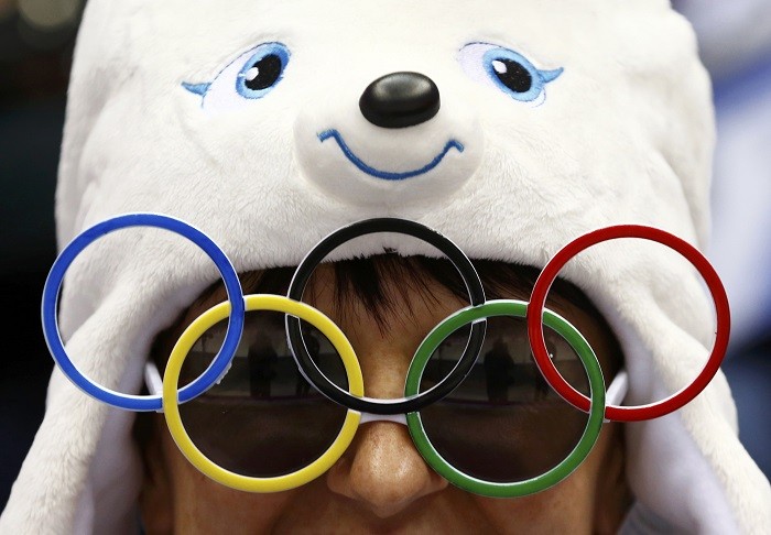 A fan wears sunglasses in the shape of the Olympic rings during the women's ice hockey bronze medal game between Sweden and Switzerland at the Sochi 2014 Winter Olympic Games, 20 February. Olympics in a Different Perspective
