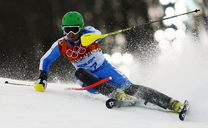 Italy's Stefano Gross clears a gate during the first run of the men's alpine skiing slalom event at the 2014 Sochi Winter Olympics at the Rosa Khutor Alpine Center, 22 February. Alpine Skiing
