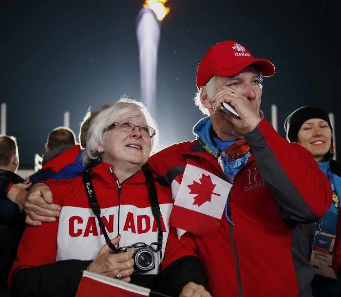 Wayne (R) and Jane, parents of Canada's gold medallist Dawn McEwen, attend the victory ceremony for the women's curling competition at the 2014 Sochi Winter Olympics, 22 February. When emotions were running high...