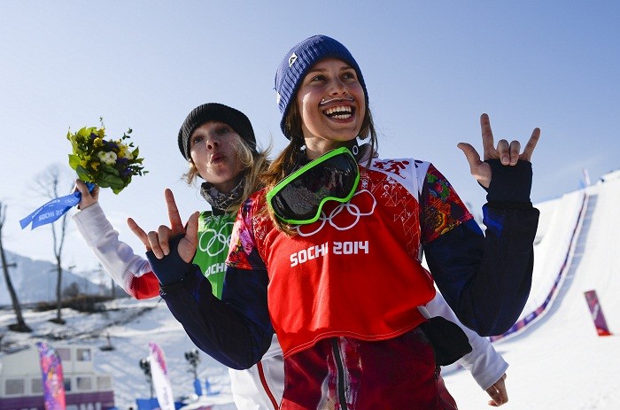Canada's second placed Dominique Maltais (L) and first placed Eva Samkova of the Czech Republic celebrate on podium after the women's snowboard cross finals at the 2014 Sochi Winter Olympic Games in Rosa Khutor, 16 February. On a lighter note...