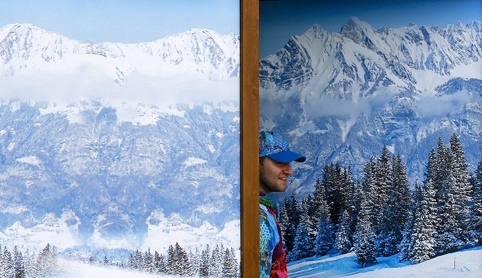 A volunteer looks out of a window as he watches the preparation for the welcoming ceremony for India's team, in the Olympic athlete's village which stands on a mountain plateau in Rosa Khutor, during the 2014 Winter Olympic Games, 16 February. Look out