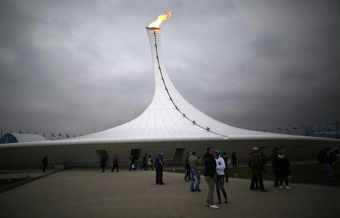 Visitors walk in front of the cauldron at the Olympic Park during the 2014 Sochi Winter Olympics, 16 February. Olympic Park