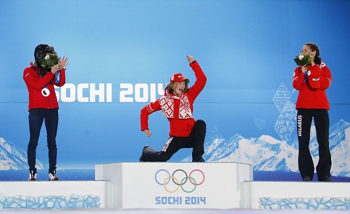 (L to R) Silver medallist Switzerland's Selina Gasparin, gold medallist Belarus' Darya Domracheva and bronze medallist compatriot Nadezhda Skardino celebrate during the victory ceremony for the women's biathlon individual 15 km event at the Sochi 2014 Winter Olympics in Sochi, 15 February. Celebrations!