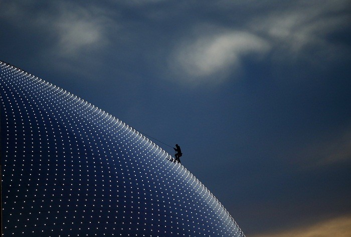 A person climbs on the Bolshoi Dome, one of the ice hockey venues, before the medals ceremony during the 2014 Sochi Winter Olympics, 15 February. On a Mission